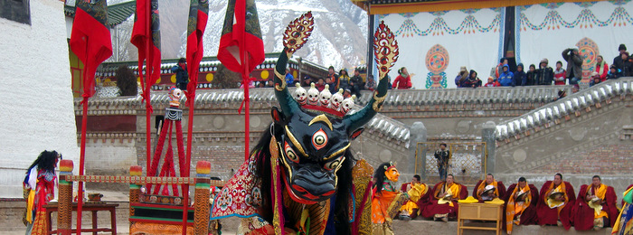 A masked dancer performs a ceremonial ritual at a monastery in Amdo