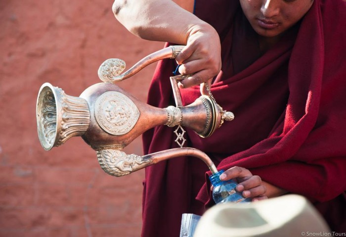 monks giving blessed water in Sera Monastery