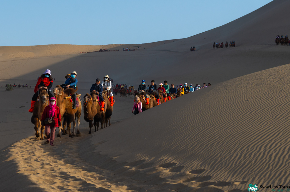 Riding a camel in Dunhuang